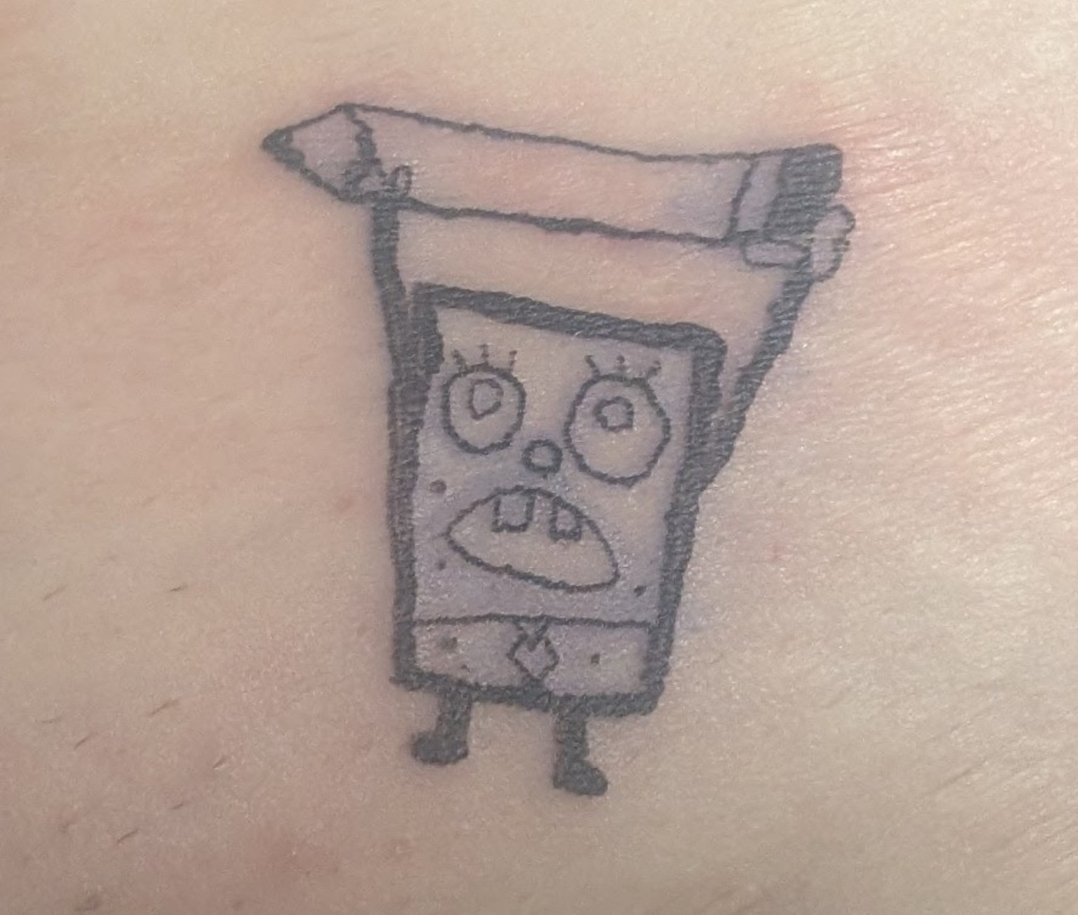 Fine-line cartoon character tattoo