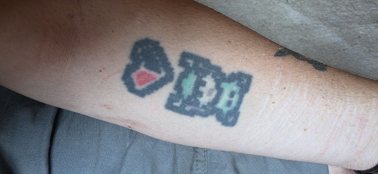 Color cartoon tattoos on a forearm
